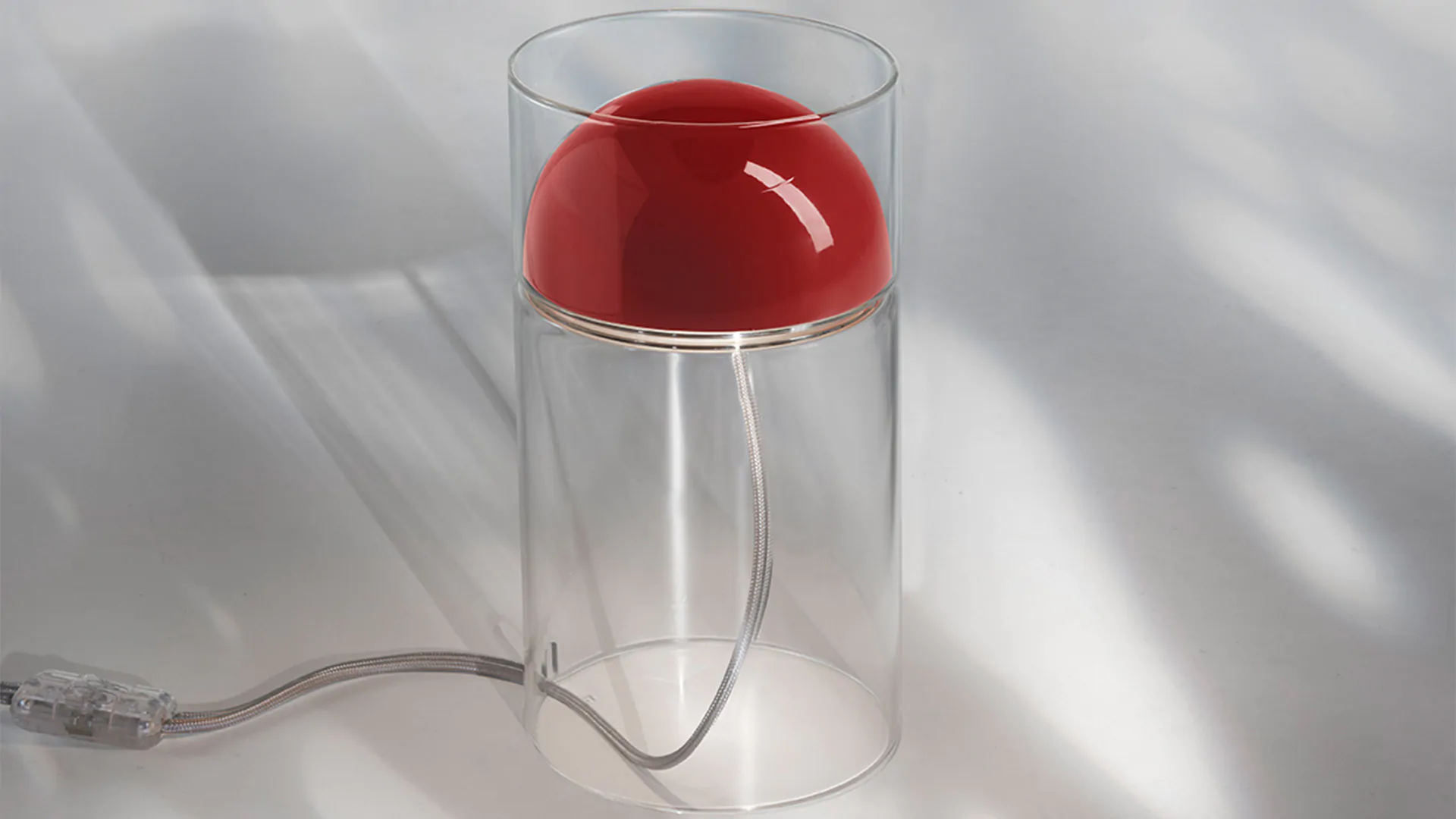 “Medusa by Oluce modern Italian table lamp – fluid glass form with glowing diffuser and sculptural elegance”