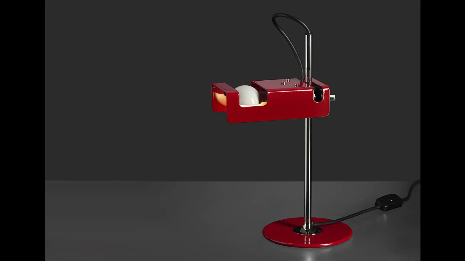 “Mini Spider by Oluce minimalist retro-style table lamp – swiveling shade with clean lines and chrome arm for accent lighting”