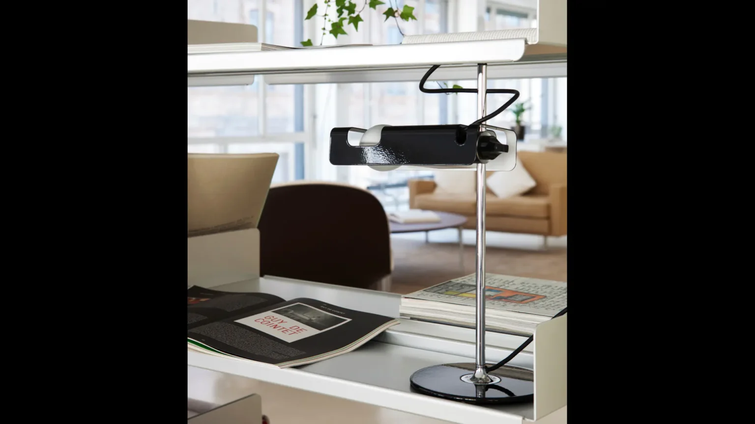 “Spider by Oluce modern Italian table lamp – iconic adjustable spotlight design with curved metal arm and cylindrical head”