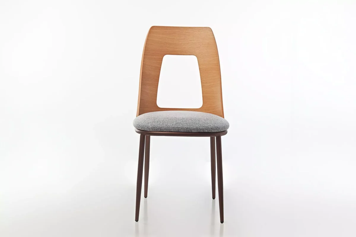 Opus W chair by Peressini featuring a gently curved, fully upholstered seat and backrest, supported by sleek metal legs.