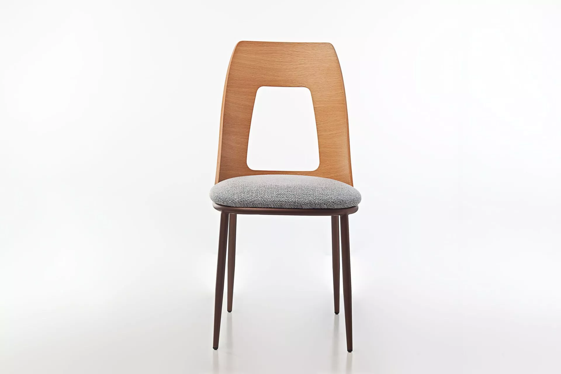 Opus W chair by Peressini featuring a gently curved, fully upholstered seat and backrest, supported by sleek metal legs.