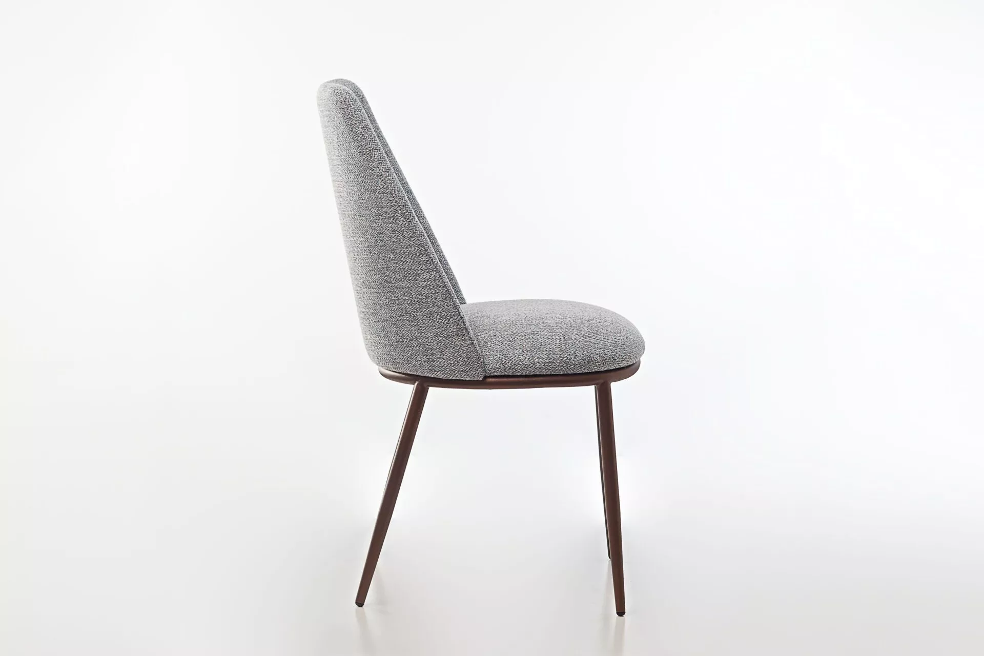 Peressini Opus Dining Chair featuring a minimalist design with a fully upholstered seat and backrest, supported by a durable steel frame with tapered metal legs, available in various fabric and leather finishes.