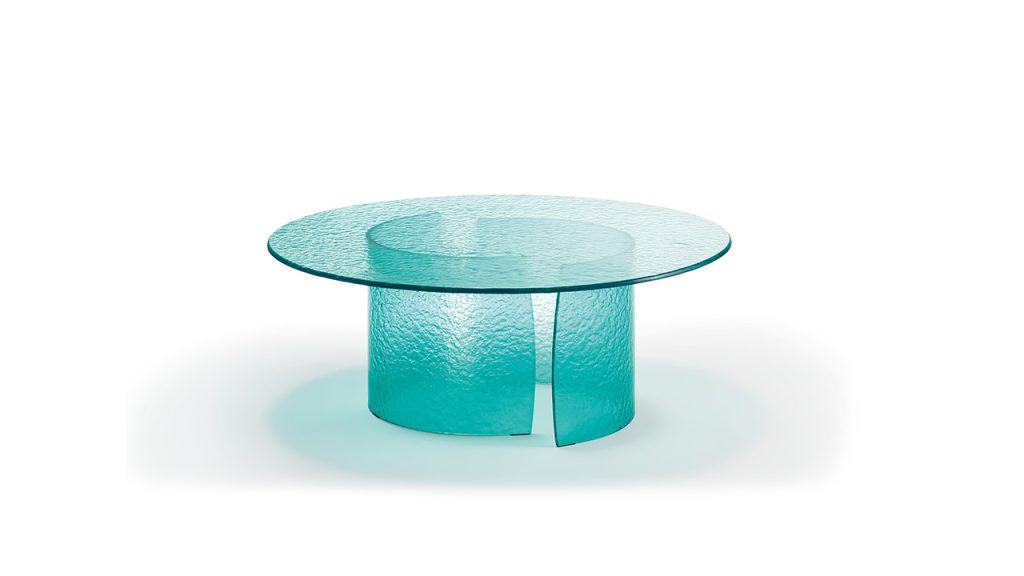 Modern Italian glass table with petal-shaped top, featured in Troy Michigan showroom