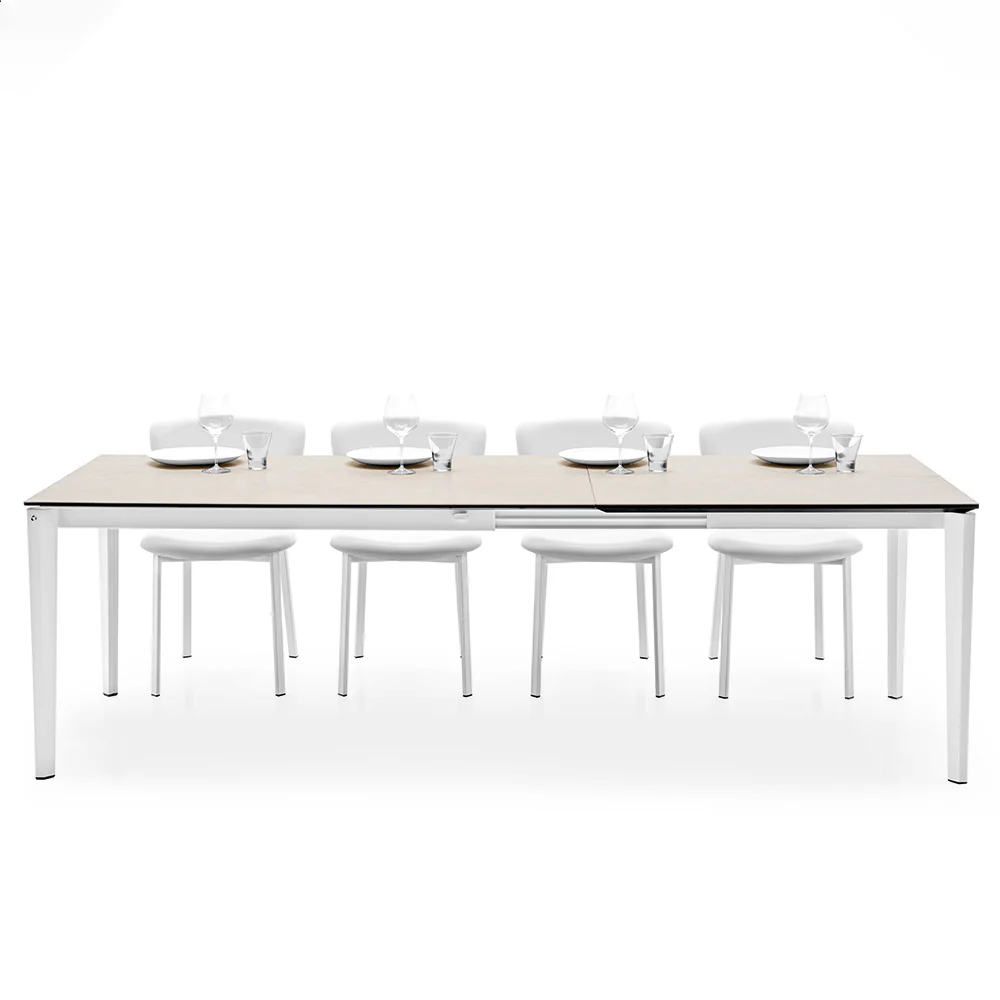 “PENTAGON FAST by Connubia in styled setting – extendable designer table with bold angles and compact footprint”