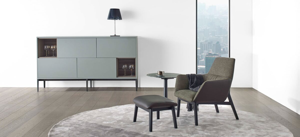 Modern low-back chair with soft upholstery and sleek wooden frame by Camerich.