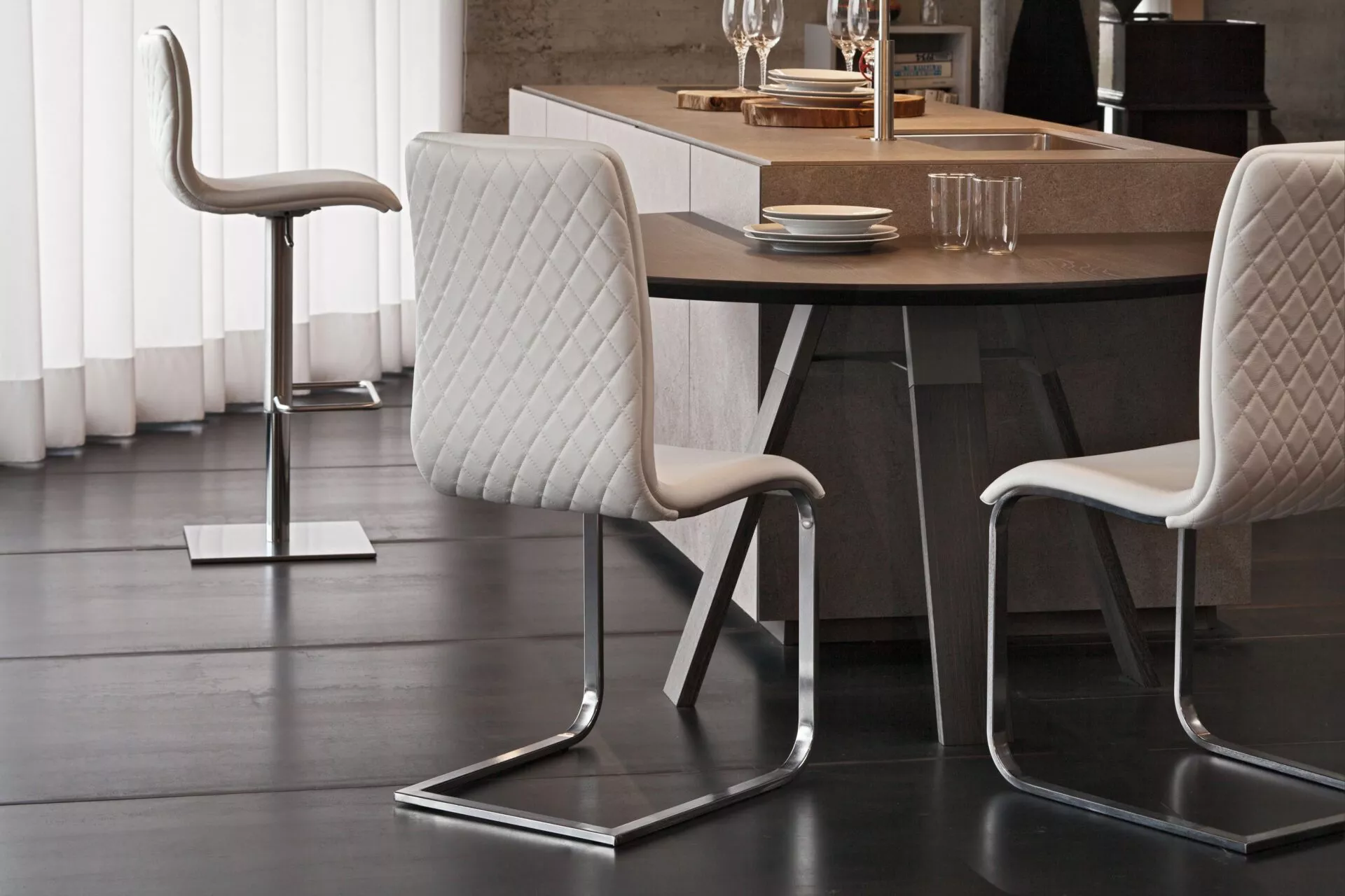 Peressini Opus Dining Chair featuring a minimalist design with a fully upholstered seat and backrest, supported by a durable steel frame with tapered metal legs, available in various fabric and leather finishes.