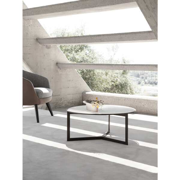 Round coffee table by Nicoline Italia featuring a medium-sized marble top with a sleek metal base, offering a minimalist design for modern interiors.
