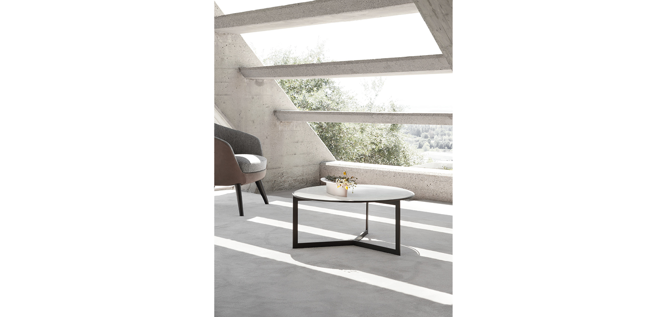 Round coffee table by Nicoline Italia featuring a medium-sized marble top with a sleek metal base, offering a minimalist design for modern interiors.