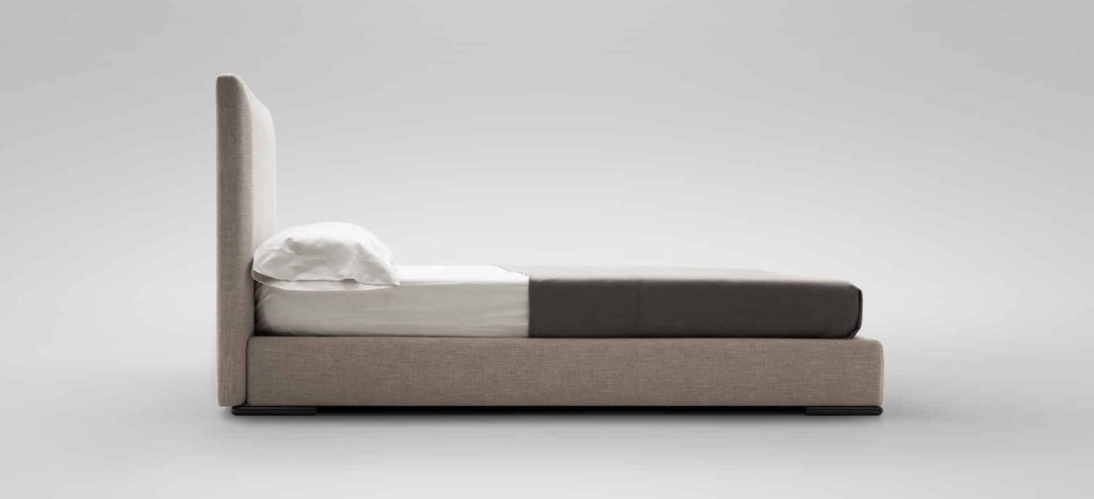 Stylish bed featuring a high, structured headboard by Camerich.