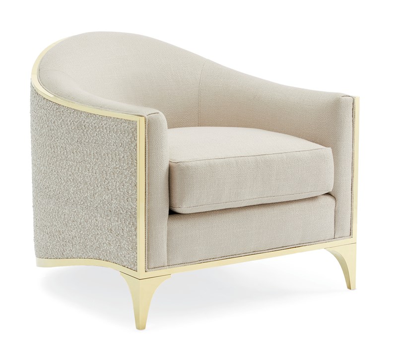 The Svelte Chair by Caracole, a sophisticated barrel chair with a shimmering Moonstone basketweave fabric interior, a tone-on-tone novelty eyelash embroidery exterior, and a Majestic Gold stainless steel frame.