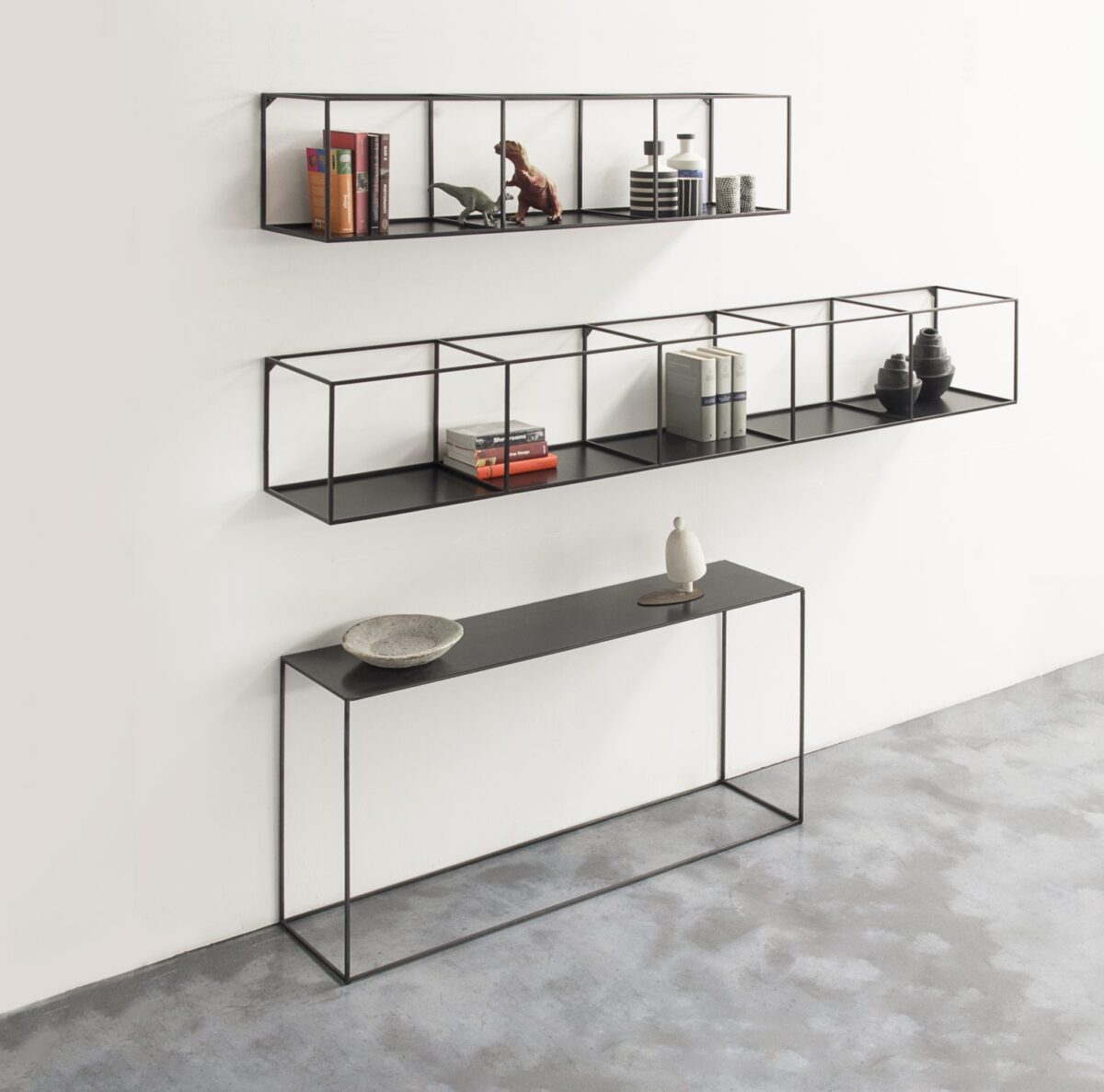 Wall-mounted rack with slim steel frame and open design by Zeusnoto.
