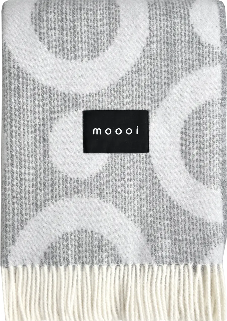 Moooi’s Blushing Sloth Blanket with charming animal artwork and vibrant colors.