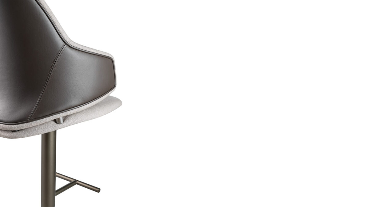 Luxury Vela Sgabello bar stool by Reflex Angelo in Royal Oak, MI – with a resin and wood shell, upholstered in leather or fabric, quilted backrest, and a height-adjustable metal base in titanium finish.