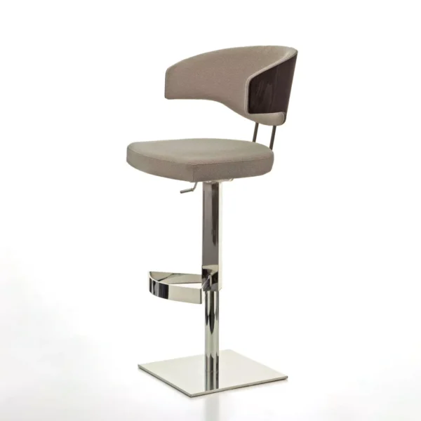 Venus W stool by Peressini in light grey quilted upholstery, round seat with mid-height backrest, on white pedestal base in a concrete-walled room.