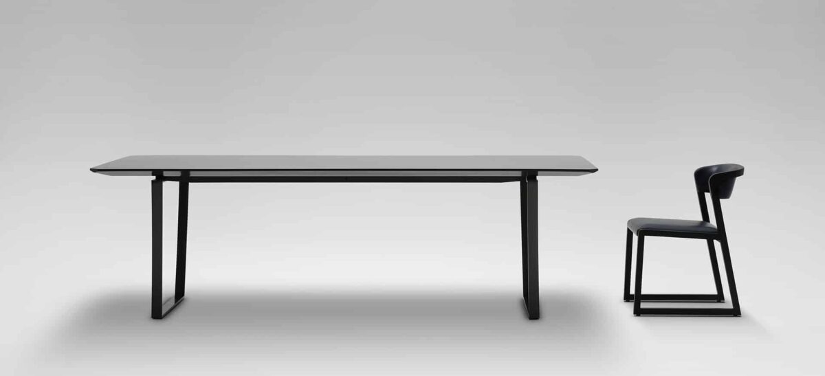 Contemporary Verge Table by Camerich, designed with a polished wood surface and minimalist metal legs, perfect for dining or office settings.