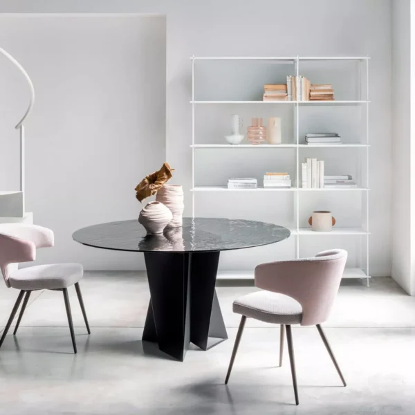 Wing chair by Peressini featuring a high, winged backrest and slim metal legs, upholstered in soft grey fabric.