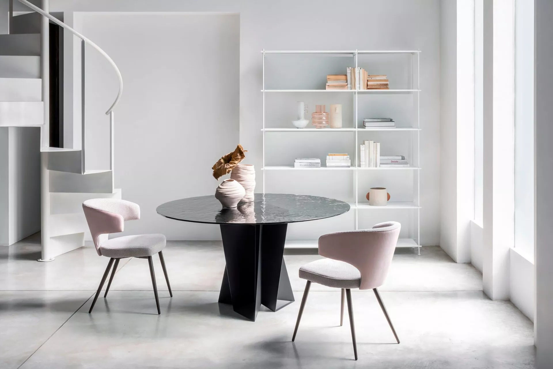 Wing chair by Peressini featuring a high, winged backrest and slim metal legs, upholstered in soft grey fabric.