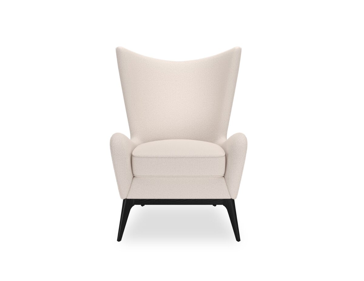 The Caracole "Whats New Pussycat?" wing chair, featuring a modern Scandinavian design with a light-colored upholstered body, gracefully sloped arms, a soft round back, and a distinctive exposed wood detail on the outback in a Modern Walnut or Almost Black finish.
