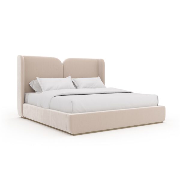 Caracole Oblique King Bed featuring a fully upholstered frame in Splendid Ivory vintage velvet, with a dramatic cleft at the center of the camelback headboard that gracefully extends along the back sides, resting on a thin plinth base finished in Soft Silver Paint Gloss.