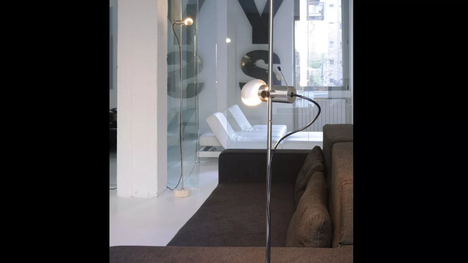 “Agnoli by Oluce designer lighting – iconic floor lamp with cylindrical counterweight base and adjustable spotlight”