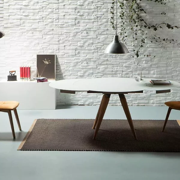 Akemi chair by Peressini with warm tan leather upholstery, featuring a stitched vertical panel backrest and slender chrome sled base, on a white studio backdrop.