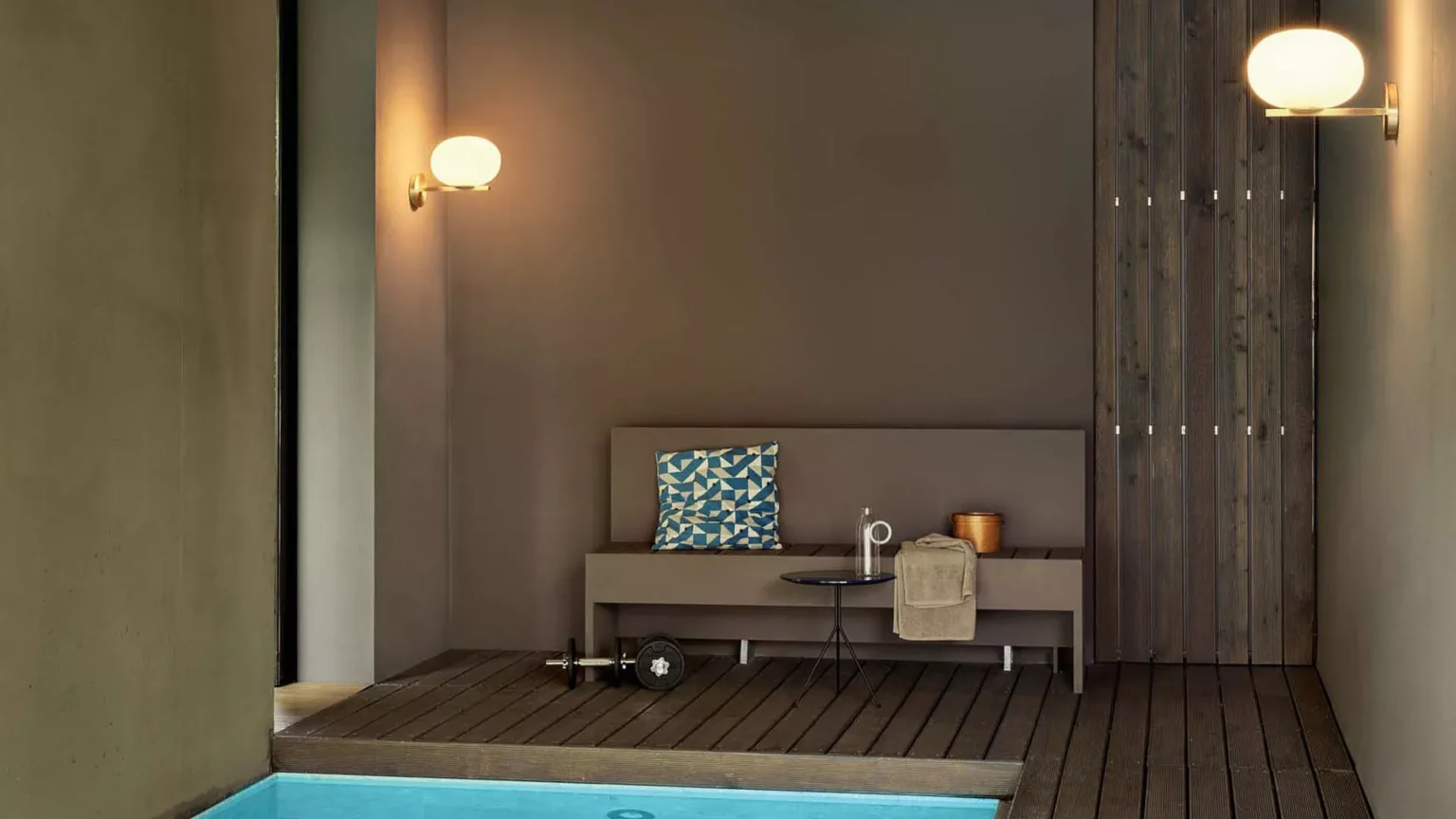“Alba by Oluce contemporary designer lighting – elegant curved metal arm supporting a glowing glass diffuser”