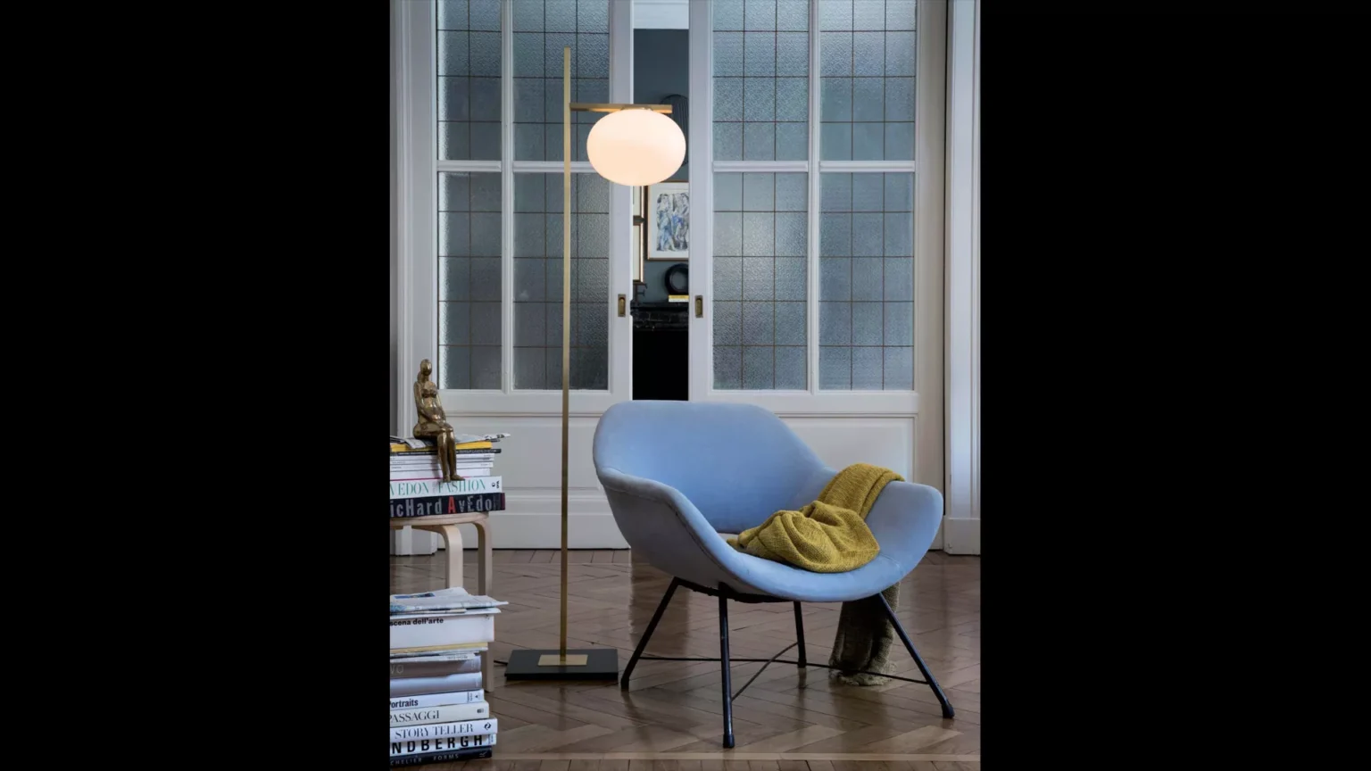 “Alba by Oluce contemporary designer lighting – minimalist lamp featuring curved metal structure and elegant glass diffuser”