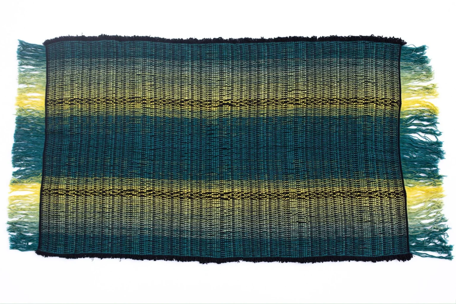 7Plaids Throw by Moroso in hand‑loomed Italian plaid design, draped over a sofa in a Royal Oak Michigan showroom