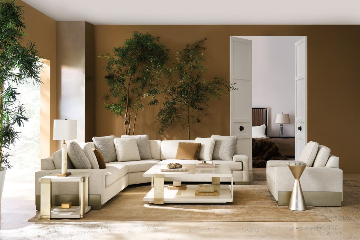 Sleek corner cocktail table in a neutral finish with two-tiered storage design.