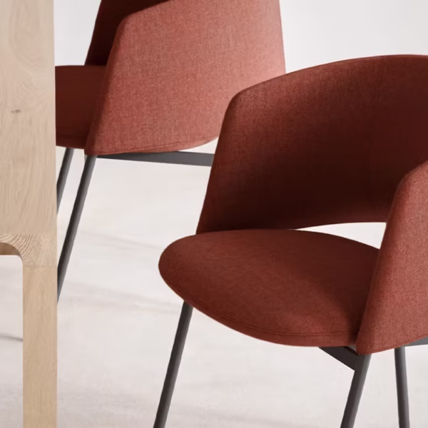 Modern dining chair with a sculptural curved backrest and sleek metal base.