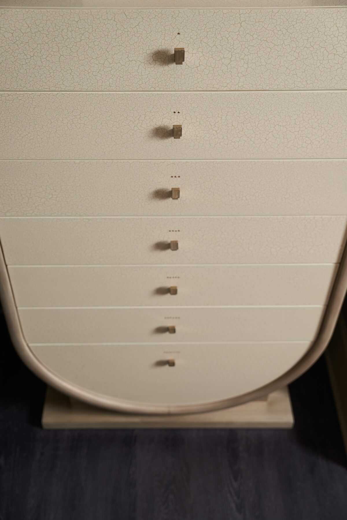 Elegant tall chest of drawers with a sculptural, Grecian-inspired form and textured finish, AMPHORA by Caracole.
