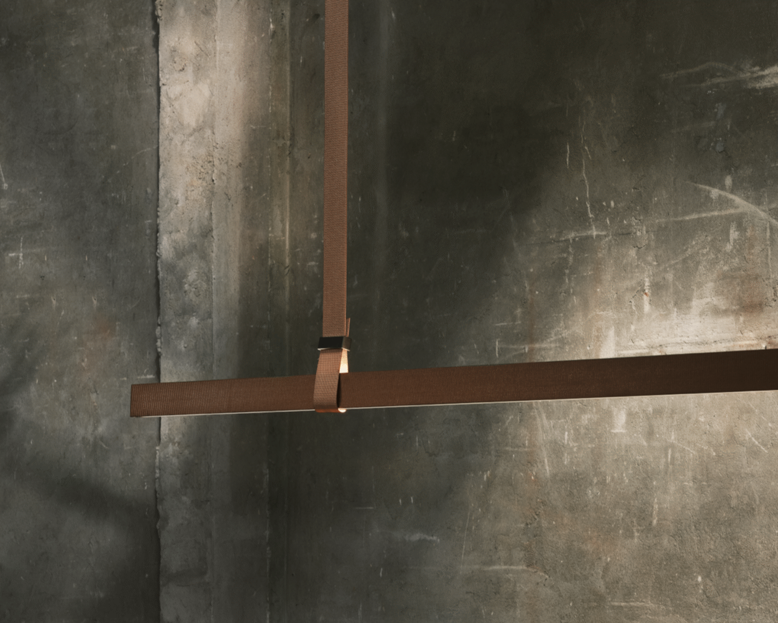 Belt Fabric pendant with leather‑covered straps routing power and suspending the lamp in a fluid, sinuous form.