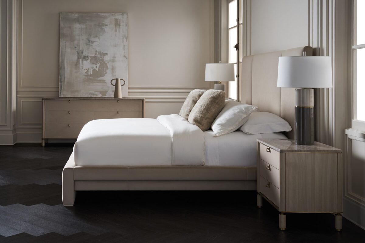 Caracole Balance King Bed with an elegant ecru upholstered headboard, footboard, and side rails, set on Parsons-style legs with Putty wood trim for added sophistication.