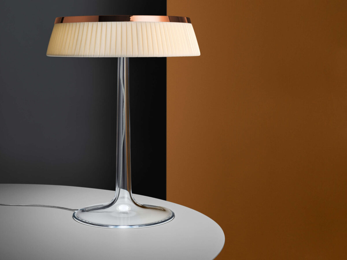 Bon Jour Table Lamp by Flos showcasing chrome crown atop transparent diffuser at the Michigan Design Center