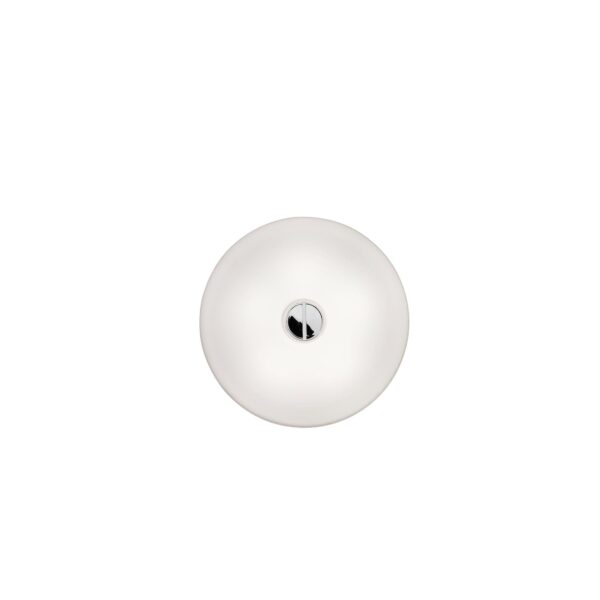 A large, round Flos Button HL lamp, featuring a flat, white opaline glass diffuser mounted flush against a wall or ceiling, providing soft, diffused light.