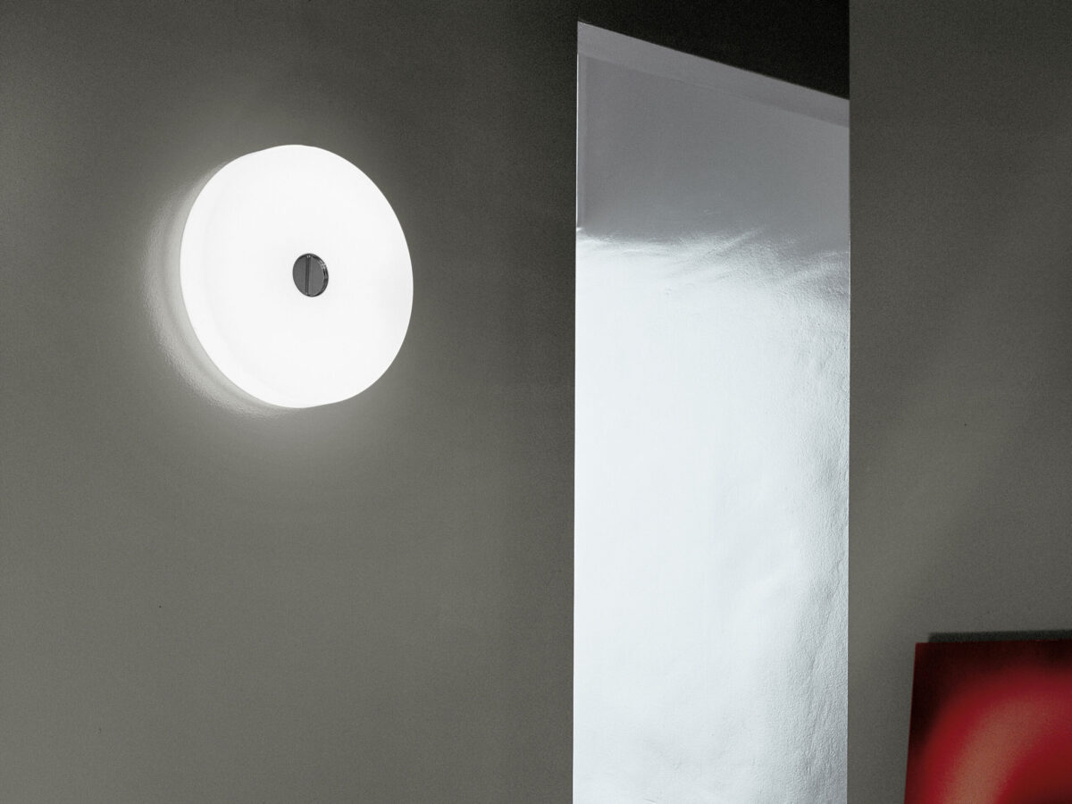A close-up of the Flos Button HL, highlighting the quality of its opaline glass diffuser and its slim profile, allowing it to seamlessly integrate with architectural elements.