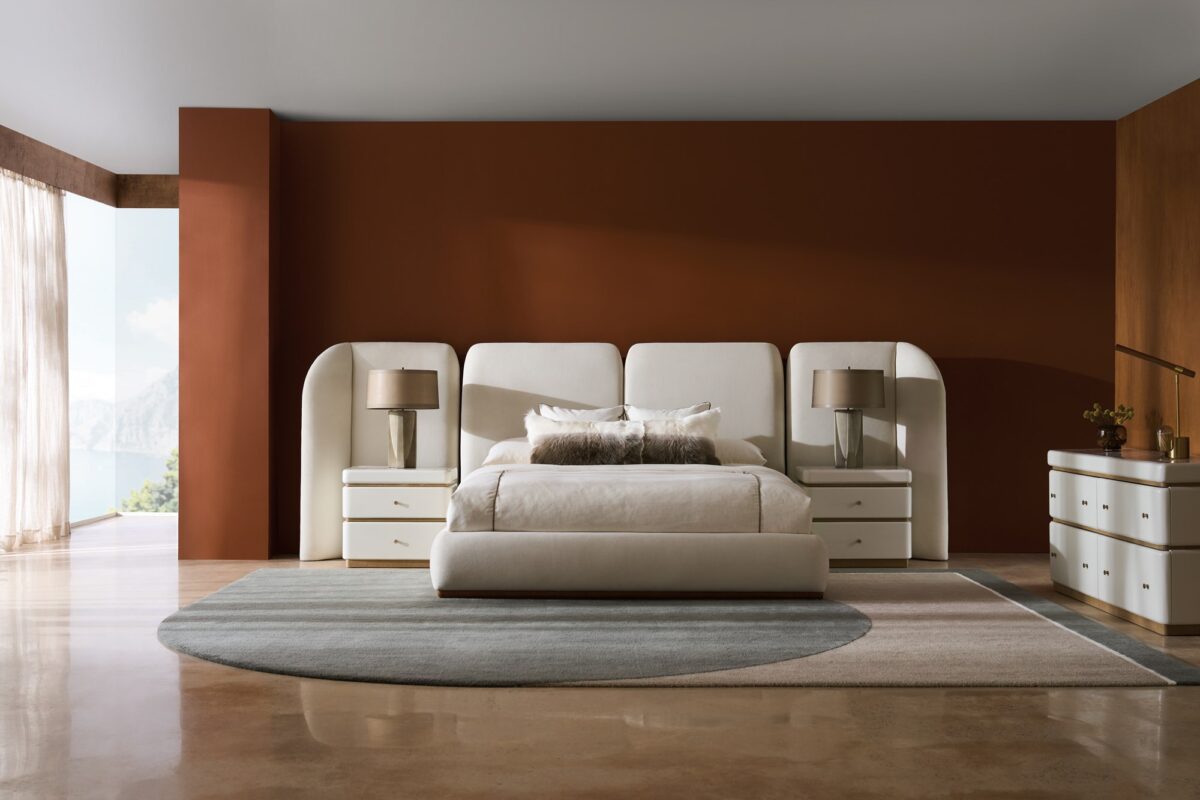 Caracole Malta Upholstered Bed Panels featuring sculptural wing panels fully upholstered in white deep-pile microfiber with Toasted Pecan wood trim, extending the headboard on either side for an architectural yet soft aesthetic.