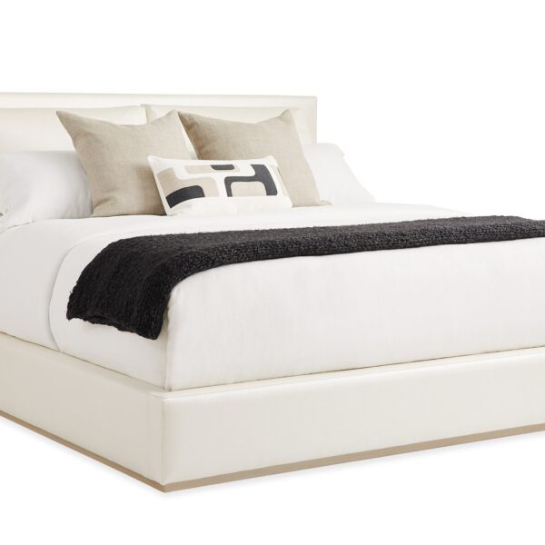 Luxurious upholstered bed with a modern, tailored headboard featuring subtle side wings, THE BOUTIQUE BED by Caracole.