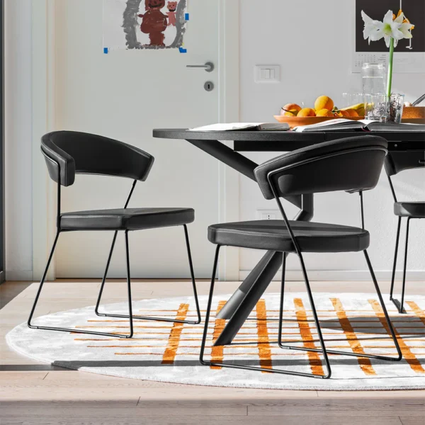 “NEW YORK by Connubia modern Italian chair – upholstered seat with wraparound backrest and sleek metal sled base”