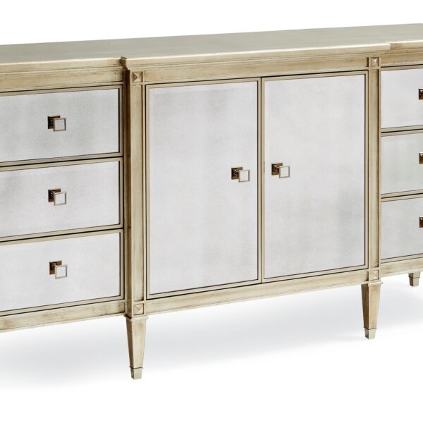 La‑Dee‑Dah Dresser by Caracole — a 74″‑wide carved dresser with six soft‑close side drawers and two mirrored center doors, finished in Auric silver leaf with beveled antique-mirror fronts, square tapered carved feet with metal ferrules, and a gold-painted interior featuring a tray drawer and shelf.