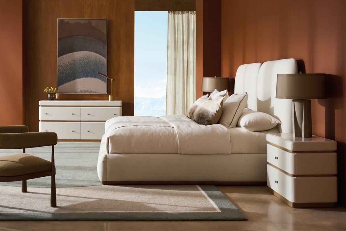 Caracole Malta Upholstered Bed Panels featuring sculptural wing panels fully upholstered in white deep-pile microfiber with Toasted Pecan wood trim, extending the headboard on either side for an architectural yet soft aesthetic.
