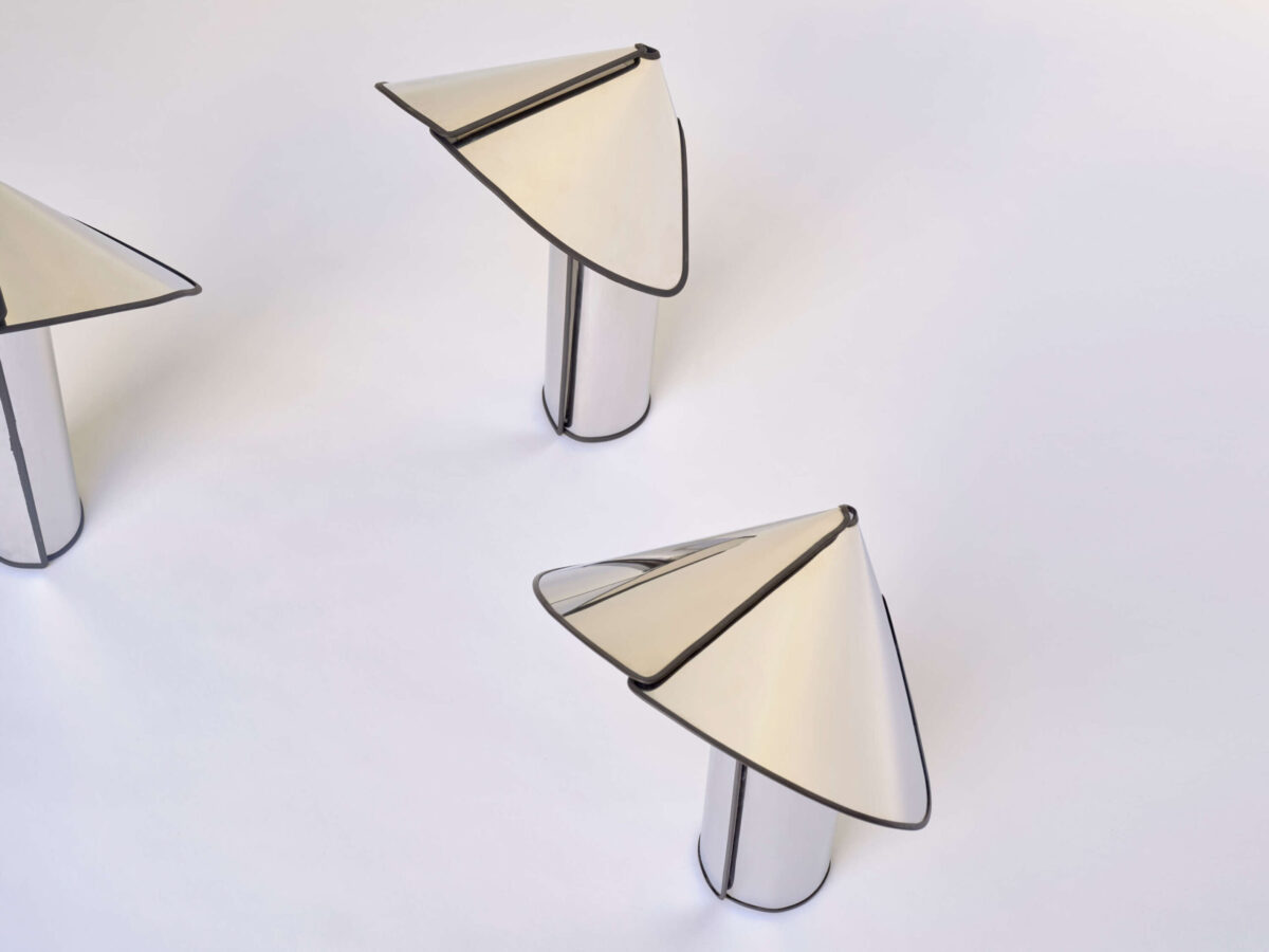 Chiara Table Lamp by Flos showcasing its origami-folded cylindrical shade and dimmable LED at the Michigan Design Center