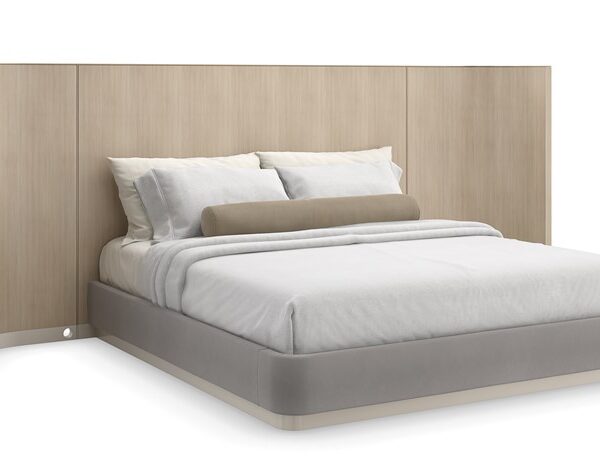 Caracole Dream Chaser King Bed with Panels featuring a parsons-shaped headboard crafted from Koto veneers finished in Dry Martini, encased in Brushed Gold metal trim, with wood-paneled wings and upholstered side rails and footboard in pale gray mohair fabric, set on a Cloud-finished wood plinth base.