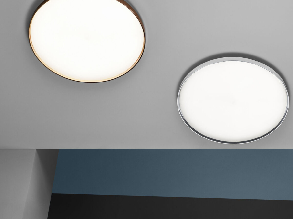 Modern and low-profile, the Flos Clara lamp, a large disc-shaped light source that mounts flush to the surface, offering soft, even illumination for various spaces.