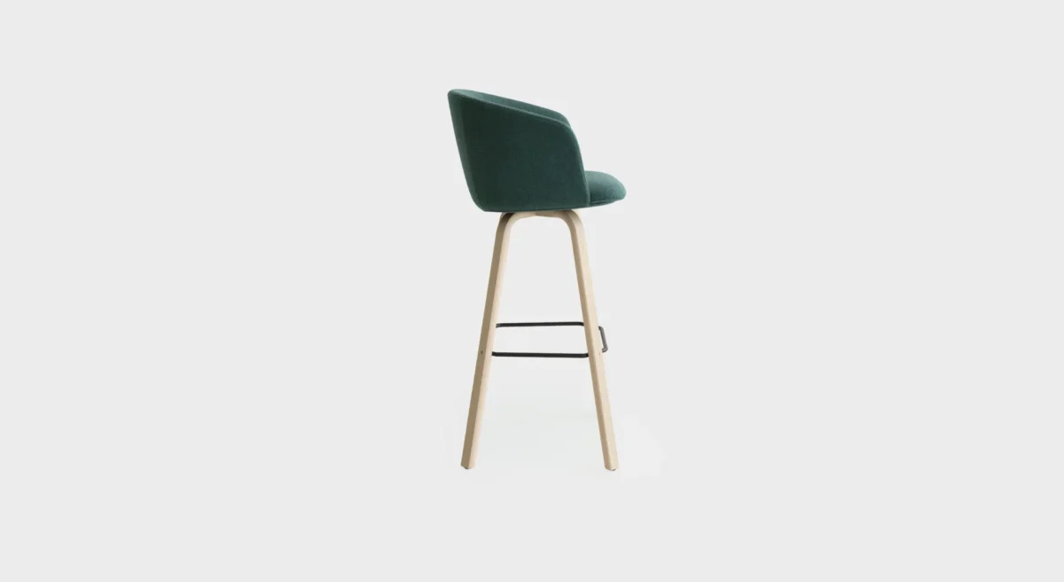 “Lapalma Glove S475 stool in mustard yellow upholstery with bleached oak base, positioned at a high-top table in a stylish café setting.”