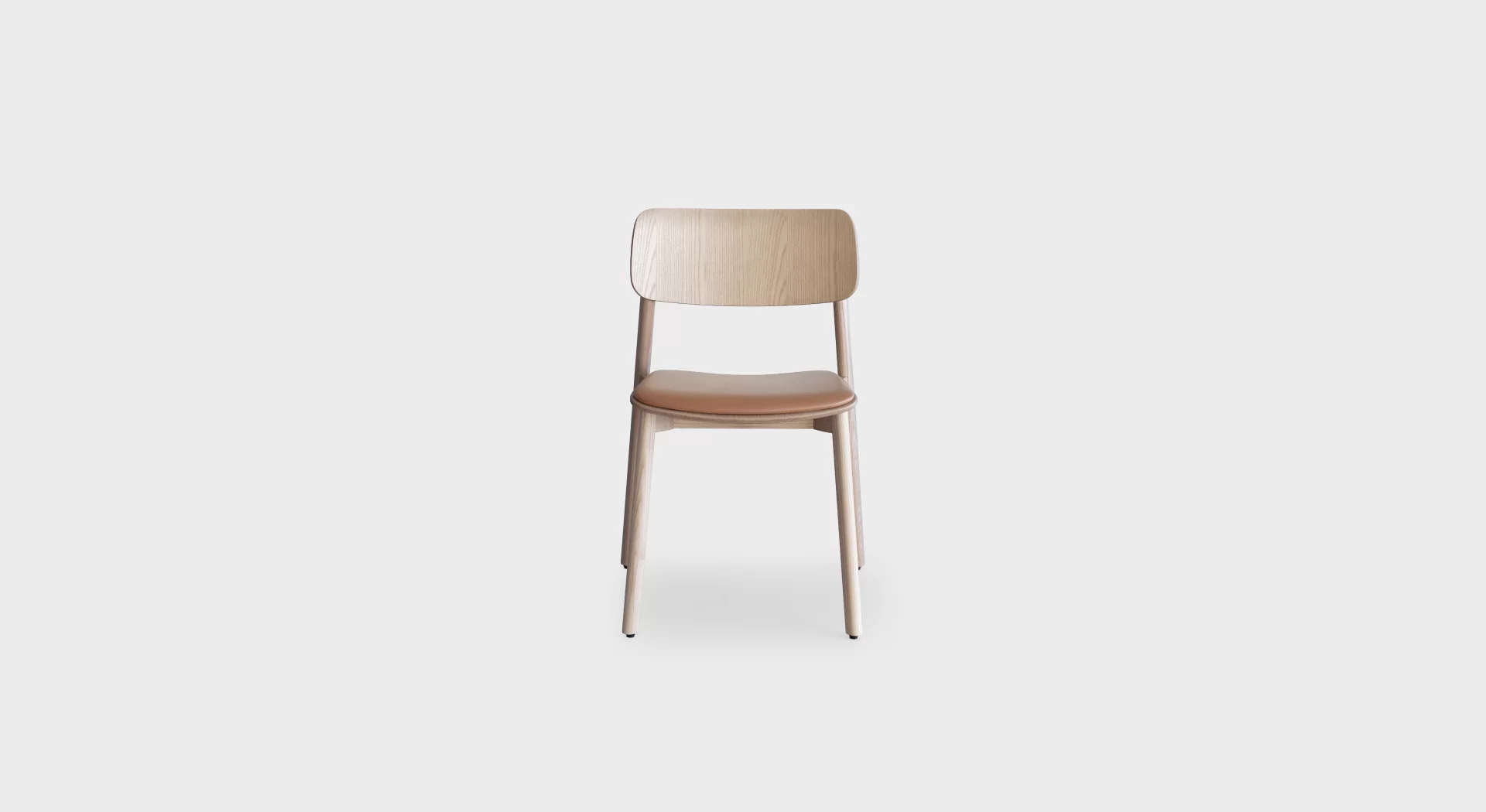Lapalma Oiva S371 stackable wooden chair with solid ash frame, curved plywood backrest, and upholstered seat pad in fabric or leather.