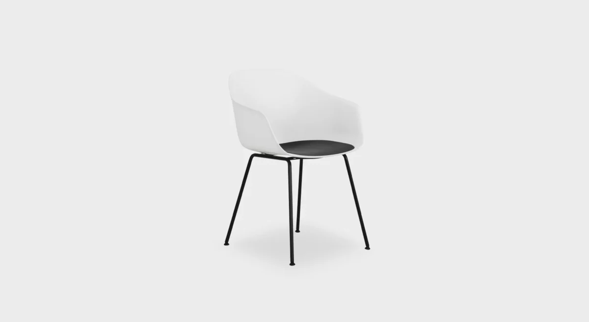 Minimalist Seela S312 chair by Lapalma, showcasing a seamless polypropylene shell with a wooden seat insert, and a durable four-legged steel base.