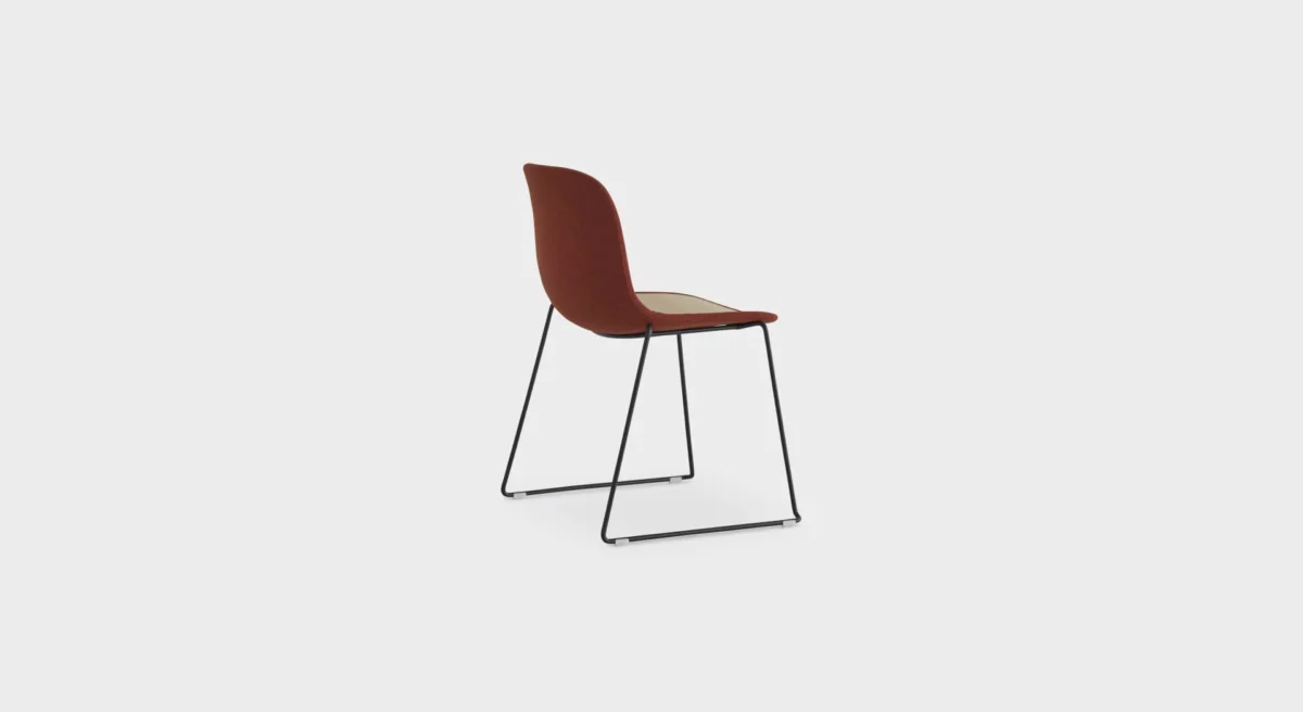 Lapalma Seela S310 dining chair with ergonomic polypropylene shell and minimalist sled base, available in black or white.