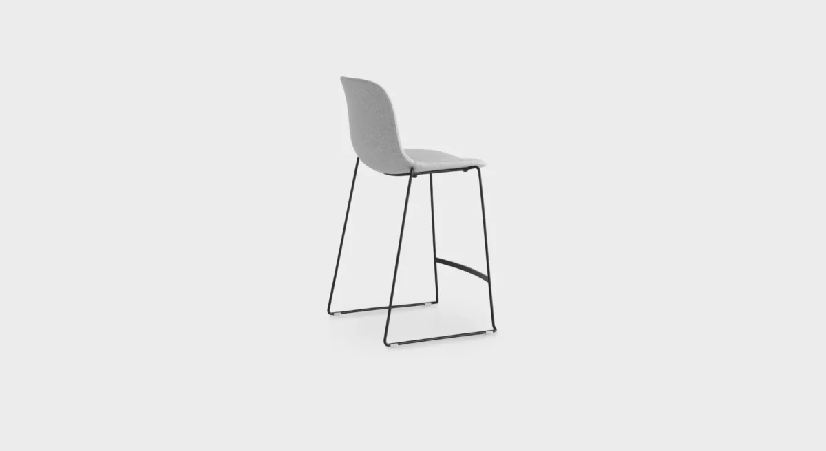 Lapalma Seela S320 H65 counter stool with polypropylene shell, upholstered seat pad, and black powder-coated sled base, designed by Antti Kotilainen.