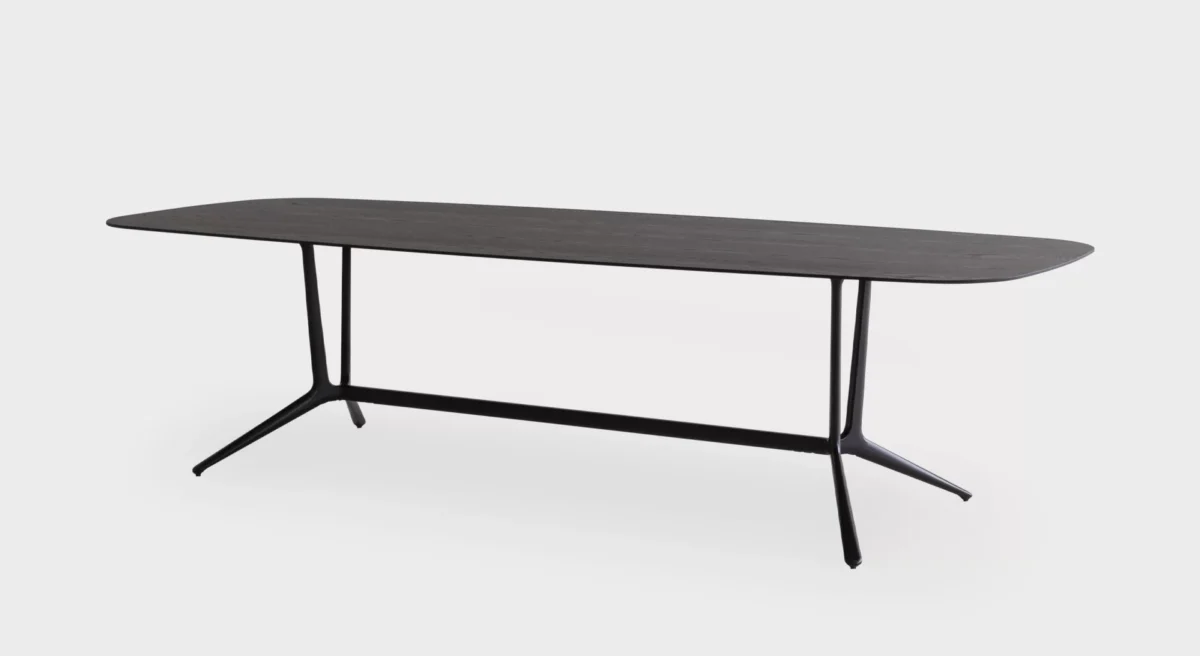 Compact round side table with slim pedestal base by Lapalma.